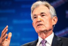 Federal Reserve holds interest rates steady, but trims economic growth outlook